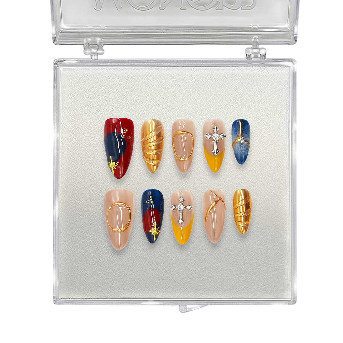 Luxury press-on nails in a bold red, blue, and gold design with cross charms, metallic accents, and geometric patterns. Perfect for elegant and artistic nail styling